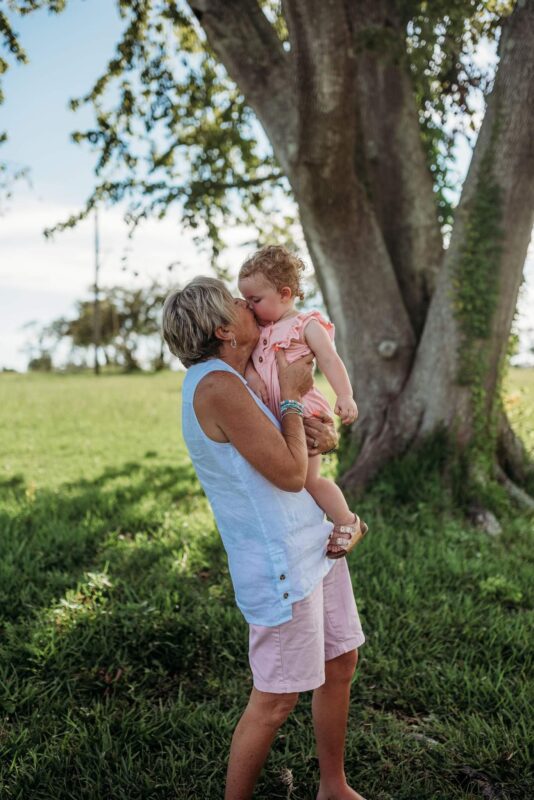 Debra holding grandchild