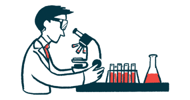 A researcher in a laboratory looks into a microscope.